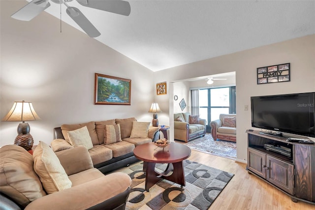 living room featuring lofted ceiling, light hardwood / wood-style flooring, and ceiling fan