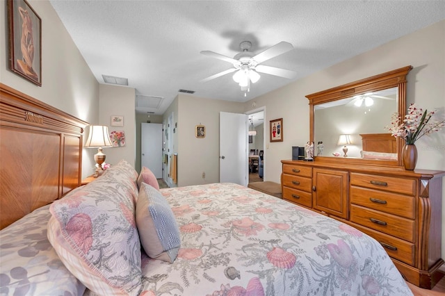 bedroom with ceiling fan and a textured ceiling