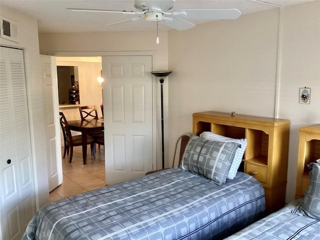 tiled bedroom with visible vents and a ceiling fan