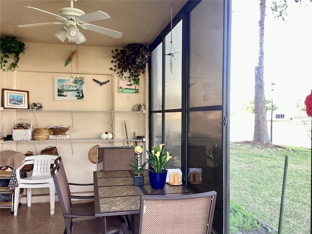 sunroom with outdoor dining space and a ceiling fan