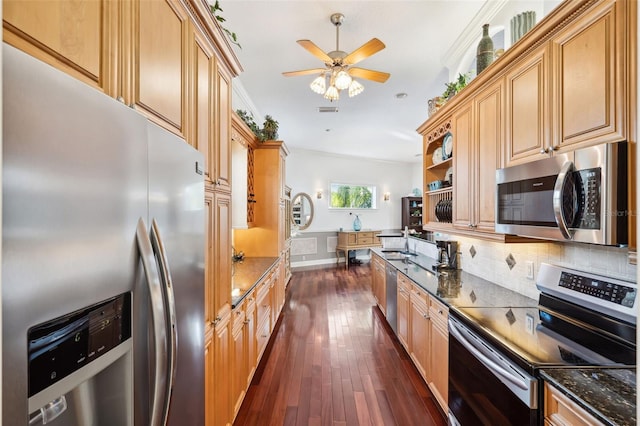 kitchen with dark wood-type flooring, sink, appliances with stainless steel finishes, dark stone counters, and decorative backsplash