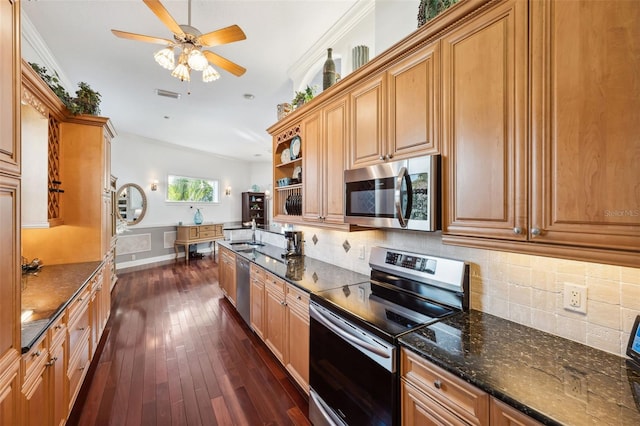 kitchen featuring dark stone countertops, appliances with stainless steel finishes, dark hardwood / wood-style floors, and backsplash