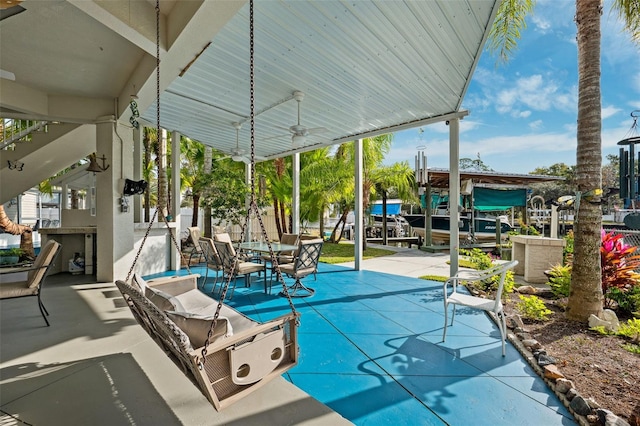 view of patio featuring ceiling fan and exterior bar