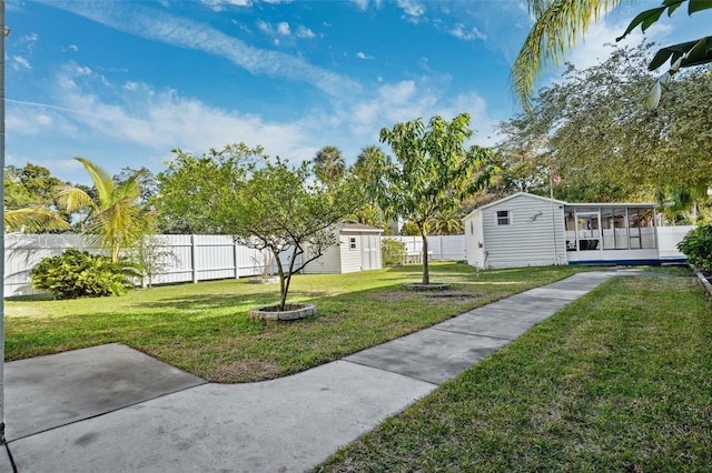 view of yard featuring a sunroom and a shed