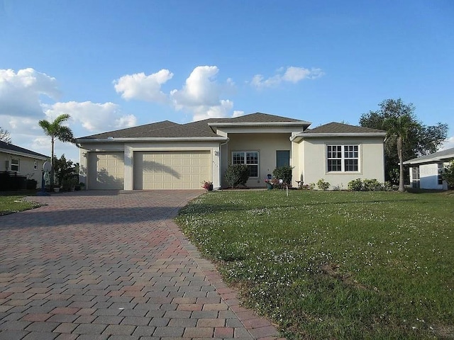 view of front of property with a garage and a front yard