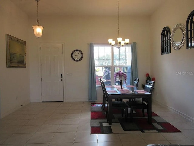 tiled dining space featuring a notable chandelier