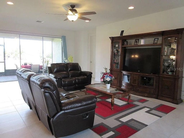 tiled living room featuring ceiling fan