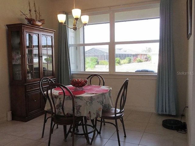 tiled dining room with a notable chandelier