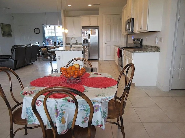 tiled dining space featuring sink