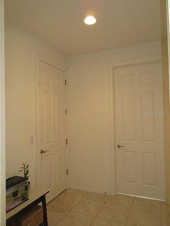 corridor featuring light tile patterned flooring