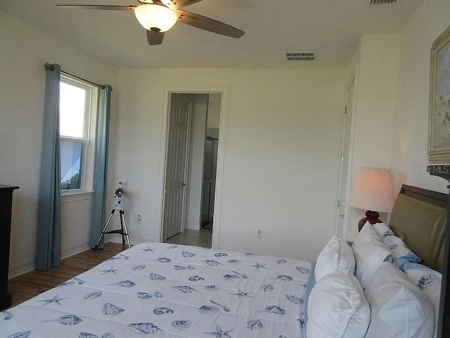 bedroom with dark wood-type flooring and ceiling fan