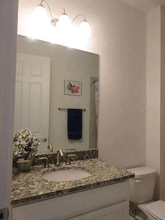 bathroom featuring vanity and toilet