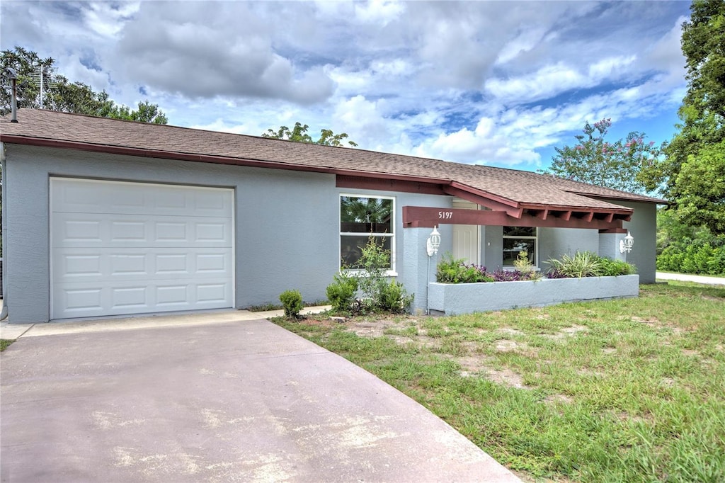 view of front of house with a garage and a front lawn