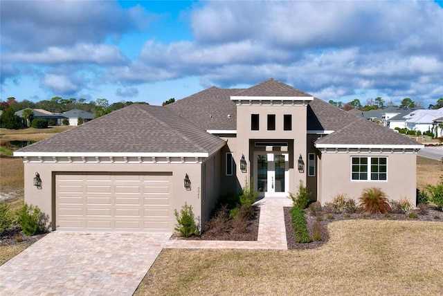 view of front of property featuring a garage, a front yard, and french doors