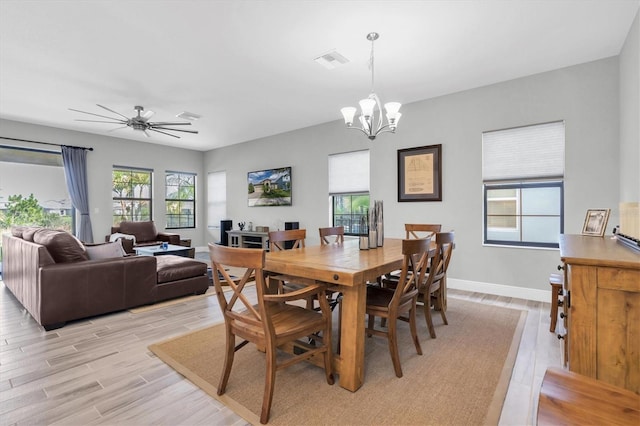 dining area with ceiling fan with notable chandelier and light wood-type flooring