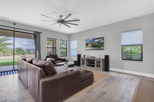 living room featuring ceiling fan and light hardwood / wood-style flooring