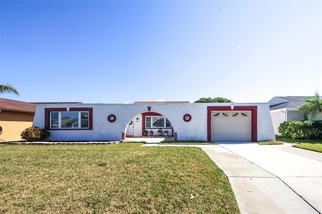 view of front of home with a garage and a front lawn