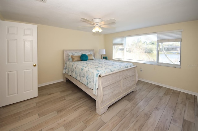 bedroom with ceiling fan and light wood-type flooring