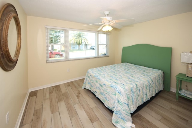 bedroom with wood-type flooring and ceiling fan