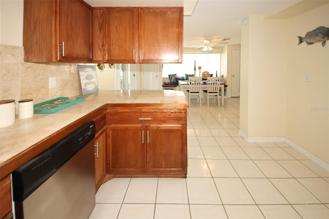 kitchen with light tile patterned floors, dishwasher, kitchen peninsula, ceiling fan, and decorative backsplash