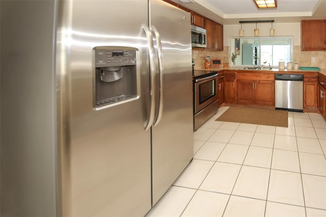 kitchen featuring tasteful backsplash, light tile patterned floors, sink, and appliances with stainless steel finishes