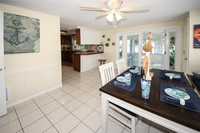 tiled dining area with ceiling fan