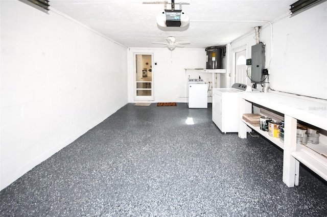 garage with water heater, a garage door opener, electric panel, and independent washer and dryer