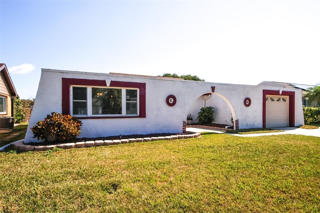 view of front of property featuring a garage, a front lawn, and central air condition unit