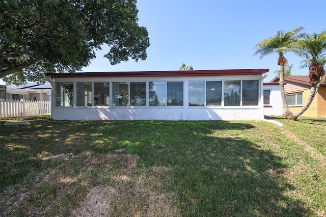 back of property featuring a lawn