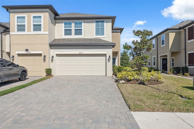 view of front of property featuring a garage and a front lawn