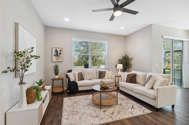 living room featuring dark hardwood / wood-style floors and ceiling fan