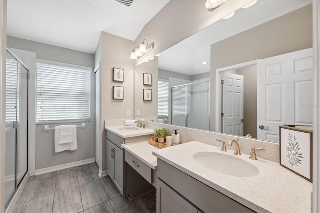 bathroom featuring vanity and a shower with shower door