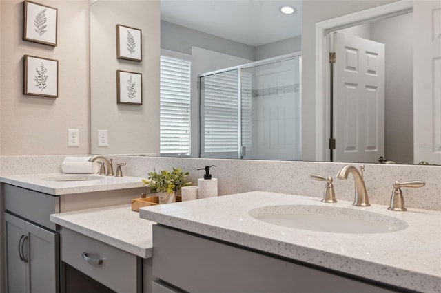 bathroom featuring walk in shower and vanity