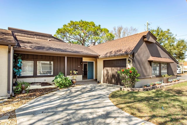 single story home with a garage and a front yard