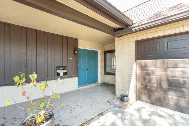 doorway to property with a garage