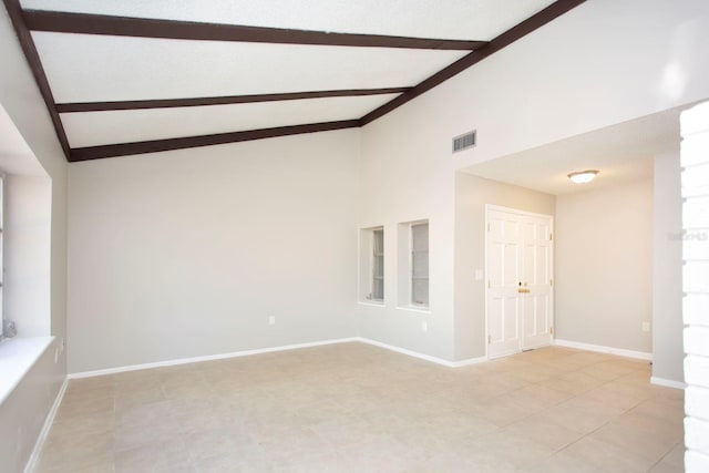 empty room with high vaulted ceiling and beamed ceiling