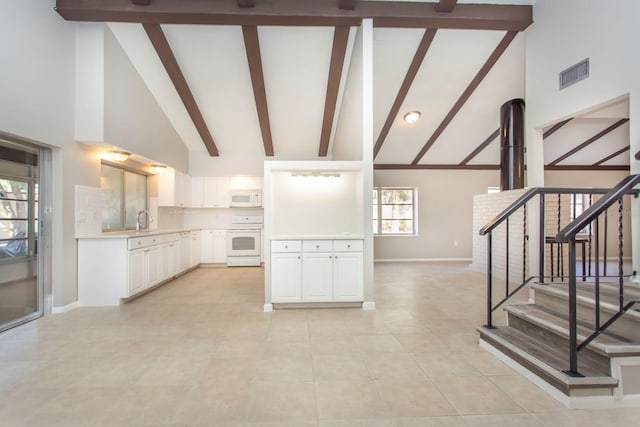 kitchen featuring sink, range, high vaulted ceiling, white cabinets, and beamed ceiling