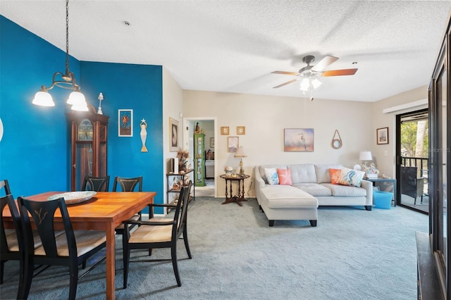 dining area with ceiling fan with notable chandelier, a textured ceiling, and carpet