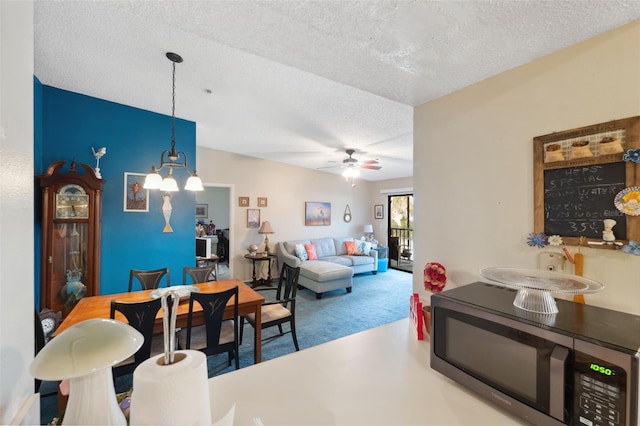 living room featuring ceiling fan, carpet, and a textured ceiling