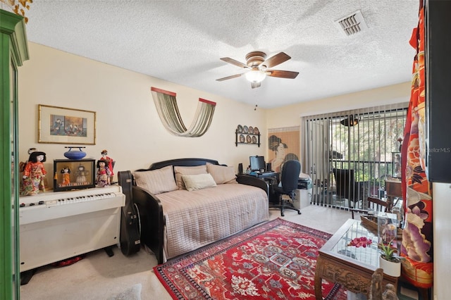 carpeted bedroom featuring ceiling fan, access to exterior, and a textured ceiling