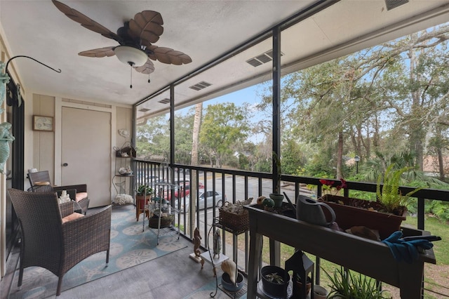 sunroom featuring ceiling fan