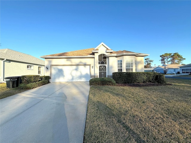 view of front of home with a garage and a front lawn