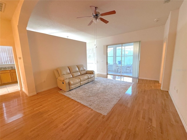 unfurnished living room featuring light hardwood / wood-style flooring and ceiling fan