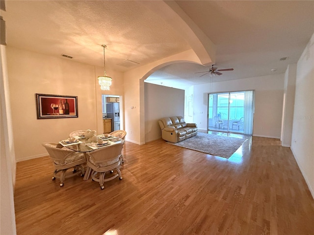 unfurnished dining area with hardwood / wood-style flooring, a textured ceiling, and ceiling fan