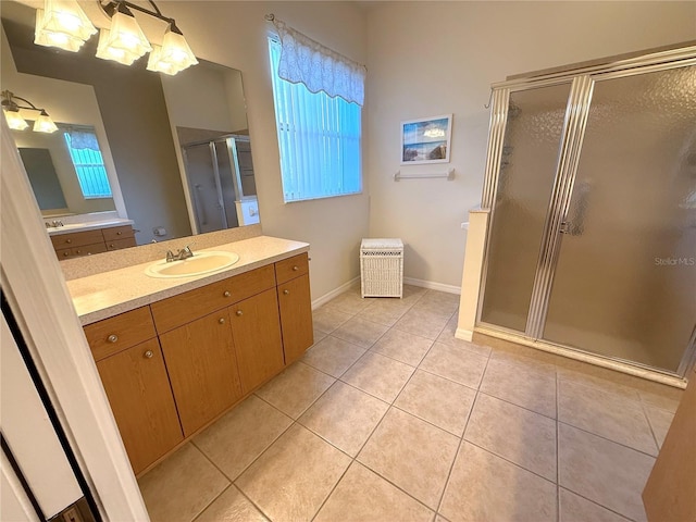 bathroom featuring tile patterned flooring, vanity, and a shower with door