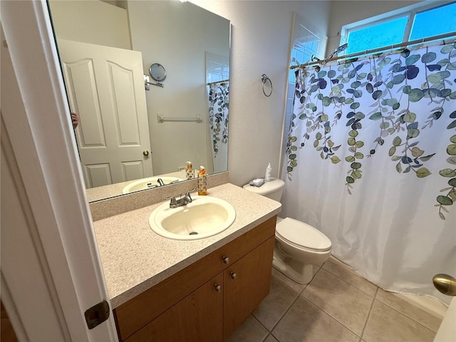 bathroom featuring tile patterned flooring, vanity, and toilet