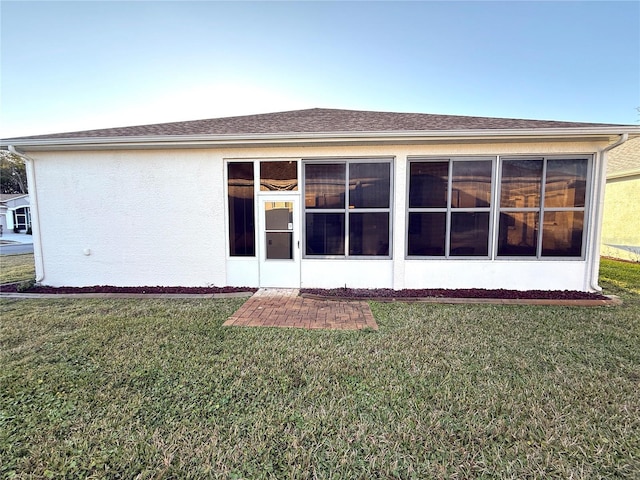 rear view of property with a lawn