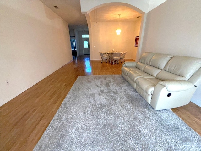 11204 Clear Oak Cir, New Port Richey, FL 34654 - living area featuring arched walkways, wood finished floors, and baseboards