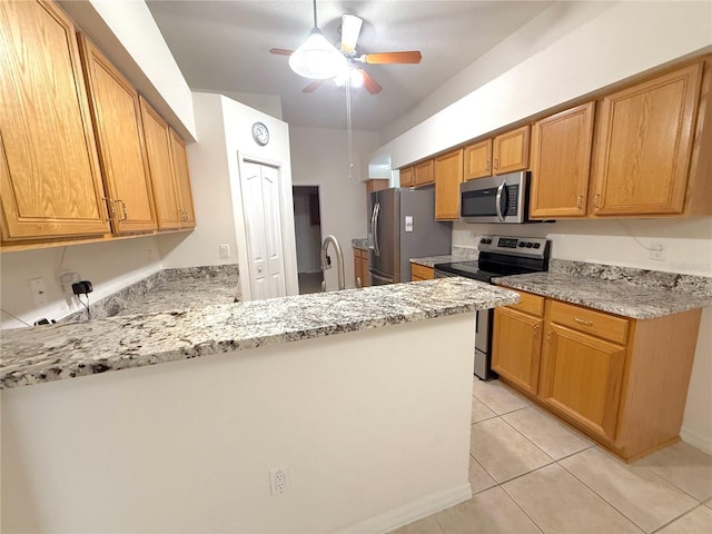 11204 Clear Oak Cir, New Port Richey, FL 34654 - kitchen with stainless steel appliances, a ceiling fan, a peninsula, light tile patterned floors, and light stone countertops
