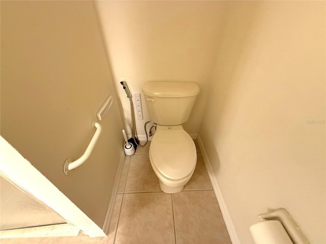 11204 Clear Oak Cir, New Port Richey, FL 34654 - bathroom featuring toilet, tile patterned flooring, and baseboards